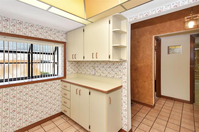 kitchen featuring white cabinetry and light tile patterned flooring