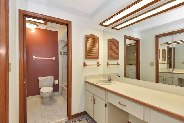 full bathroom with shower / bath combination with glass door, vanity, toilet, and washer / dryer