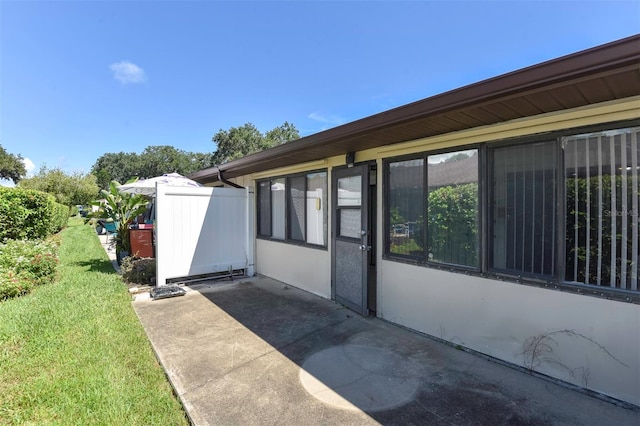 view of side of home with a patio