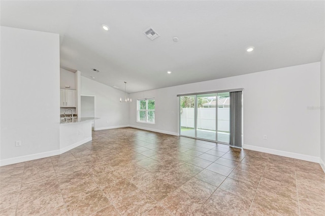 unfurnished living room featuring lofted ceiling, an inviting chandelier, and light tile patterned floors