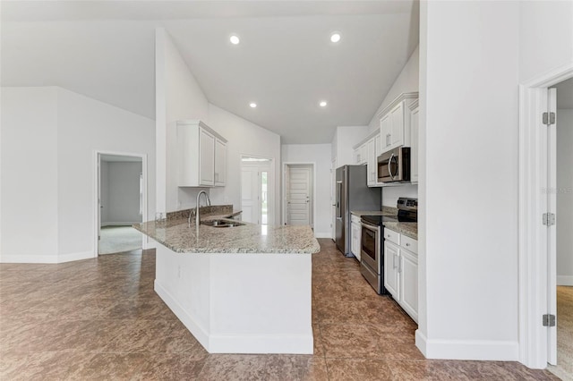 kitchen with light stone counters, stainless steel appliances, white cabinets, sink, and kitchen peninsula