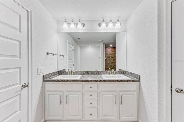 bathroom with vanity and a textured ceiling