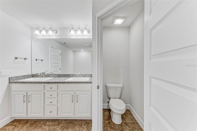 bathroom with tile patterned floors, vanity, and toilet