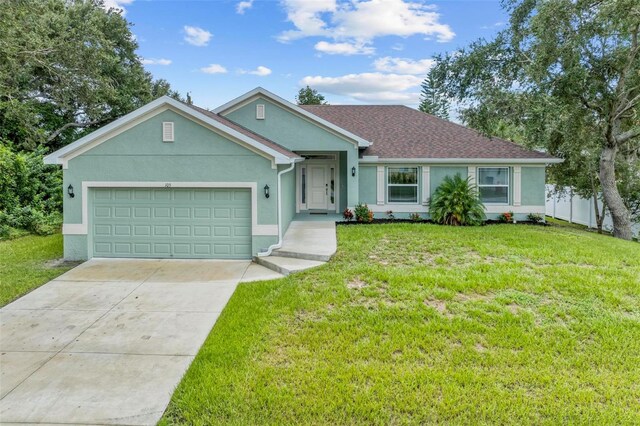 single story home with a front yard and a garage