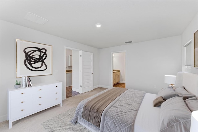 carpeted bedroom featuring ensuite bathroom