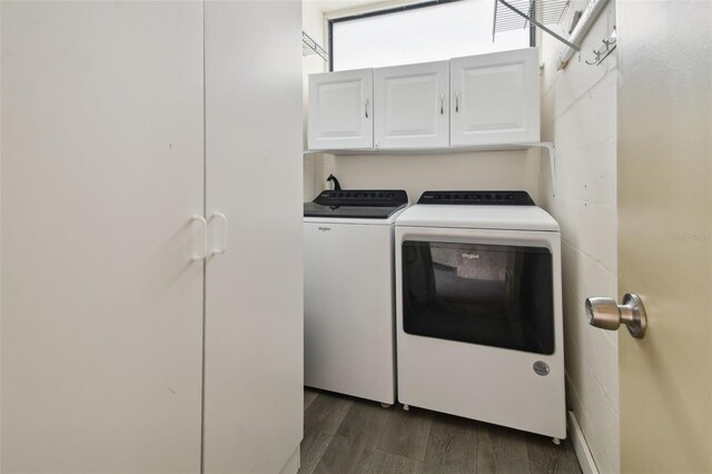 laundry room with cabinets, separate washer and dryer, and dark hardwood / wood-style flooring