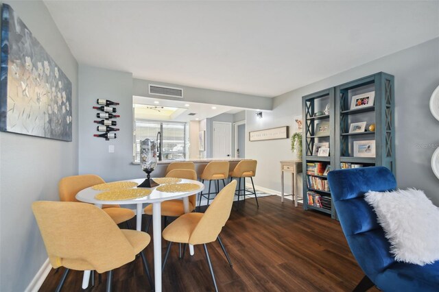 dining space with dark hardwood / wood-style flooring