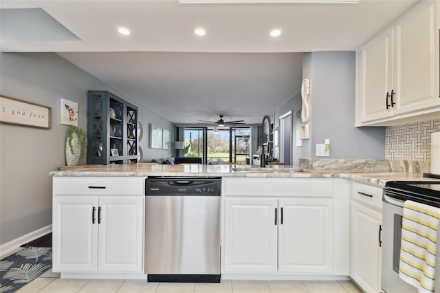 kitchen with light stone countertops, stainless steel appliances, sink, ceiling fan, and decorative backsplash