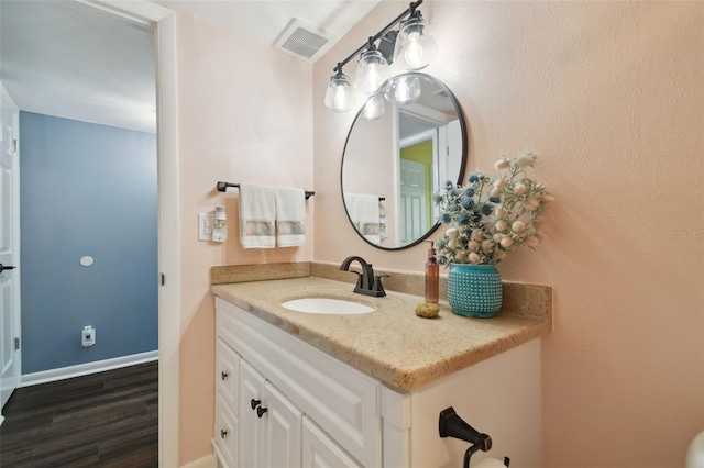 bathroom with vanity and hardwood / wood-style flooring