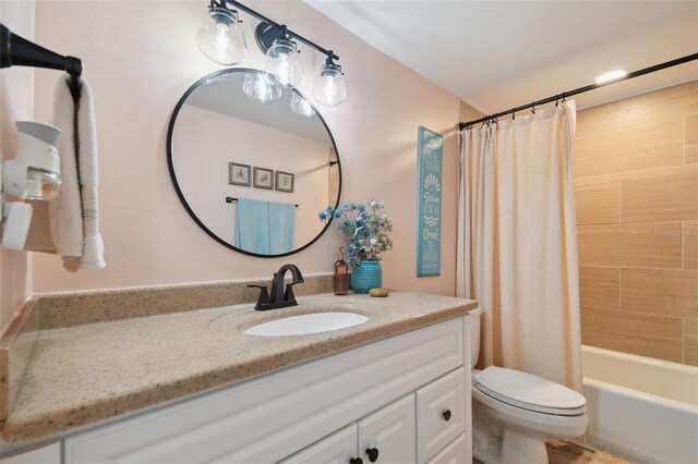 full bathroom featuring vanity, toilet, and shower / tub combo