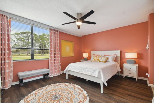 bedroom with dark wood-type flooring and ceiling fan