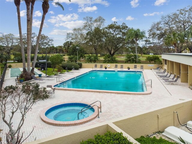 view of swimming pool with a patio and a hot tub