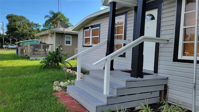 view of property exterior featuring a yard and a wooden deck