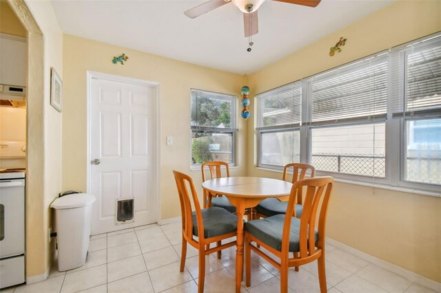 tiled dining room featuring ceiling fan