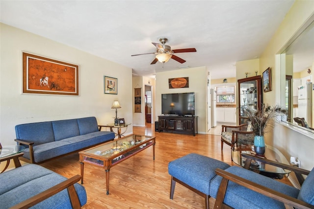 living room featuring ceiling fan and light hardwood / wood-style flooring