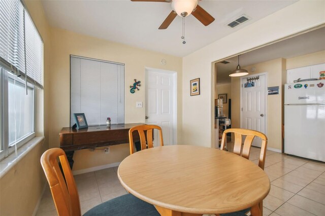 tiled dining space featuring ceiling fan