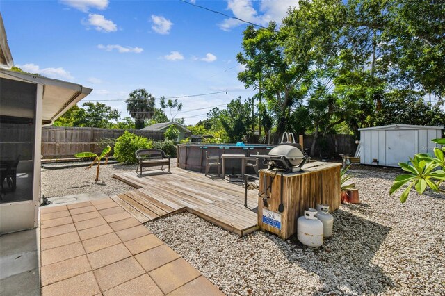 view of patio / terrace featuring a storage unit and a swimming pool side deck