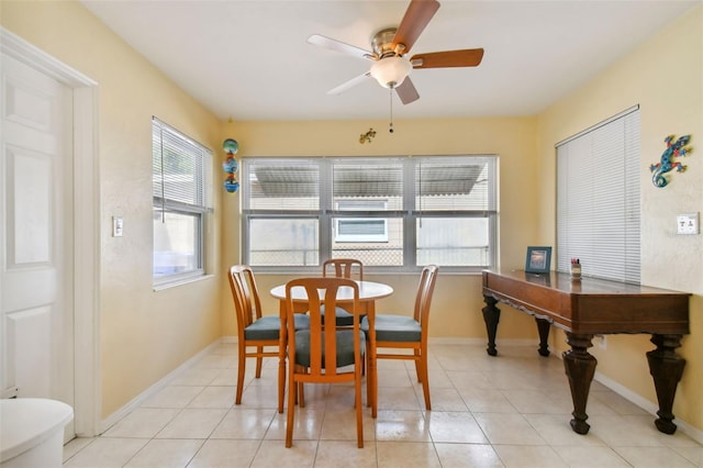 tiled dining space featuring ceiling fan