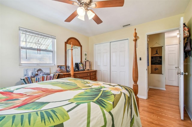 bedroom with light wood-type flooring, a closet, and ceiling fan