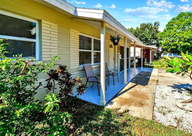 view of property exterior featuring a patio and a porch