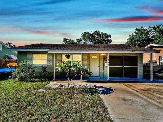 ranch-style home featuring fence, driveway, a porch, a garage, and brick siding