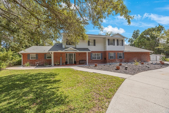 view of front of property featuring a storage shed and a front lawn