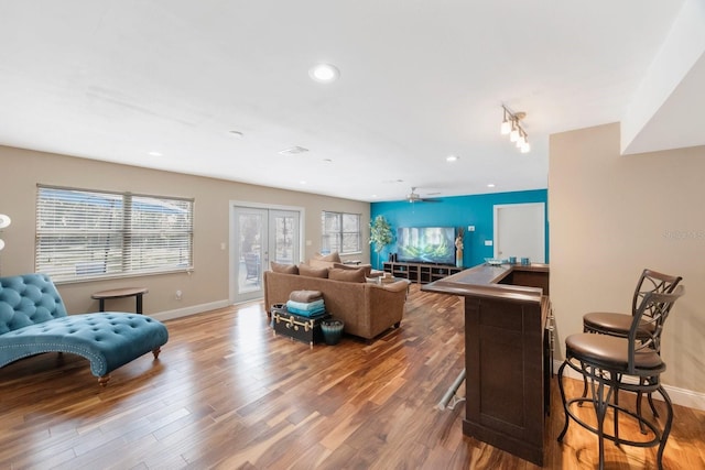 living room featuring recessed lighting, baseboards, ceiling fan, and wood finished floors