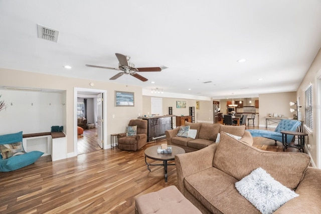 living area with wood finished floors, baseboards, visible vents, ceiling fan, and recessed lighting