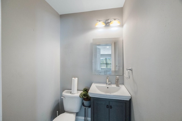 bathroom featuring toilet and vanity