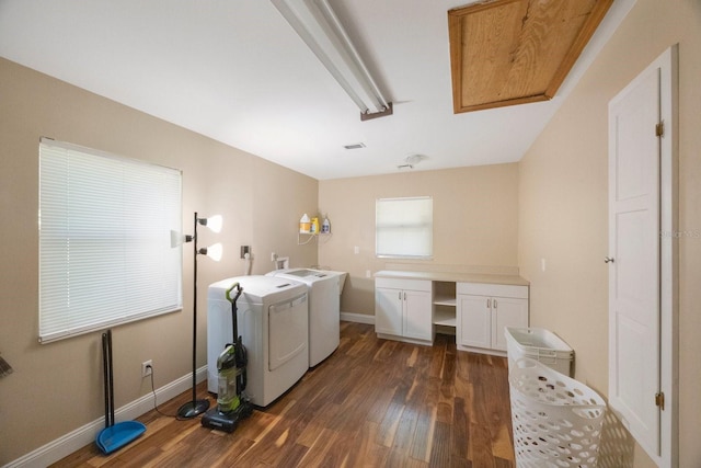 laundry area featuring dark wood-style flooring, baseboards, washer and dryer, and laundry area