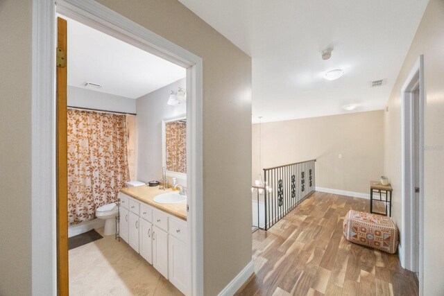 bathroom featuring vanity, toilet, hardwood / wood-style floors, and a shower with shower curtain