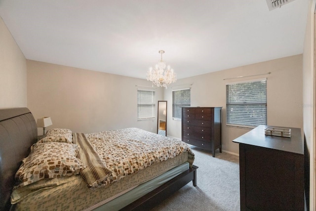 bedroom featuring baseboards, carpet flooring, multiple windows, and a notable chandelier