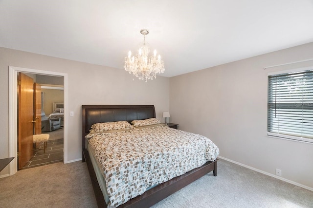 bedroom with an inviting chandelier and carpet floors