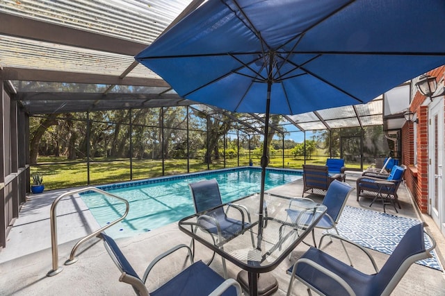 view of swimming pool featuring a lawn, a lanai, and a patio