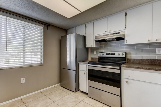 kitchen featuring stainless steel appliances, backsplash, white cabinets, and light tile patterned flooring