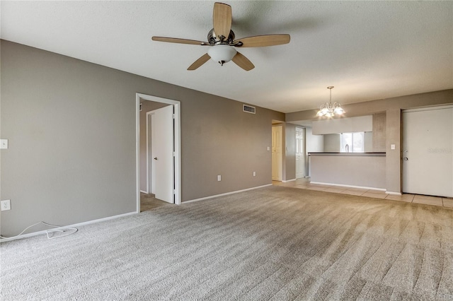 unfurnished living room featuring ceiling fan with notable chandelier, light carpet, and a textured ceiling