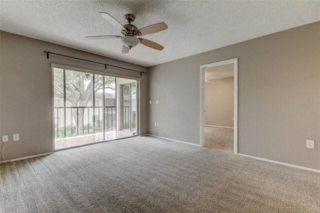 unfurnished room with a textured ceiling, ceiling fan, and light carpet