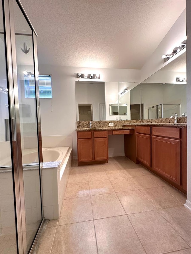 bathroom with vanity, plus walk in shower, a textured ceiling, and tile patterned flooring