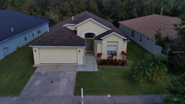 view of front of house featuring a garage and a front lawn