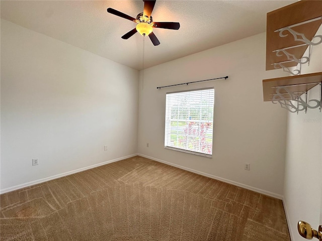 unfurnished room with baseboards, carpet floors, and a textured ceiling