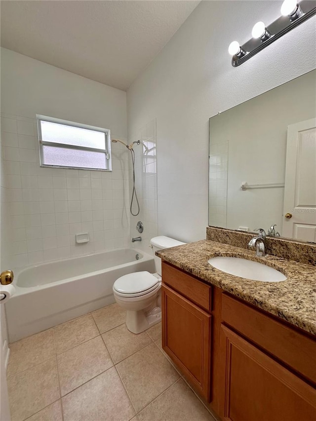 full bath featuring tile patterned floors, vanity, toilet, and washtub / shower combination