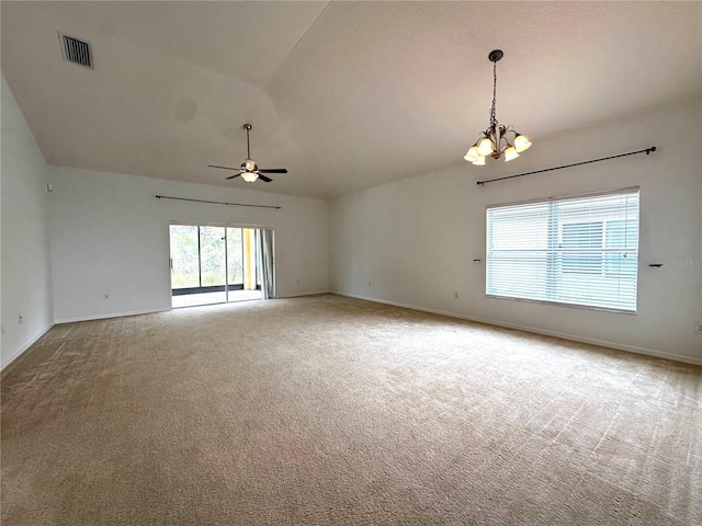 empty room featuring visible vents, carpet floors, baseboards, lofted ceiling, and ceiling fan with notable chandelier