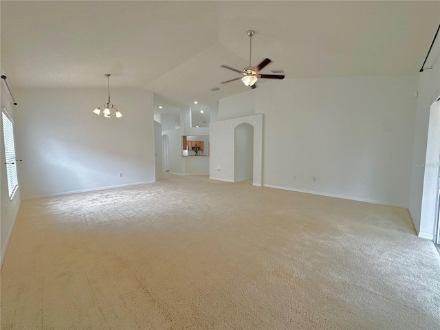 unfurnished living room featuring baseboards, ceiling fan with notable chandelier, arched walkways, and high vaulted ceiling