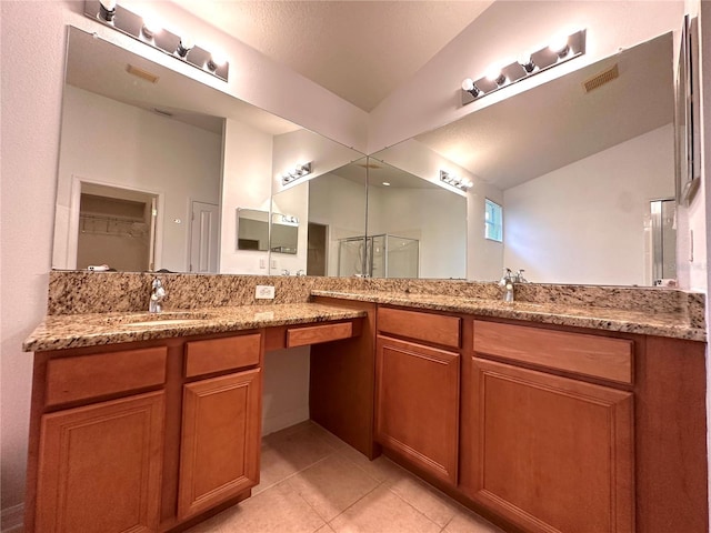 full bathroom with tile patterned flooring, visible vents, a shower stall, vaulted ceiling, and vanity