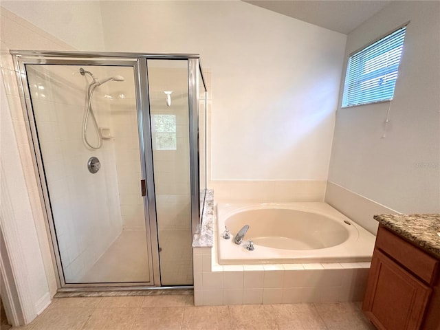 bathroom with tile patterned floors, vanity, a bath, and a shower stall