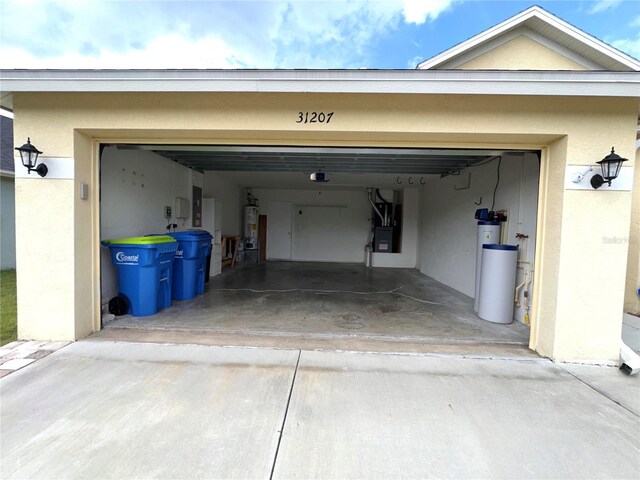 garage featuring water heater and driveway