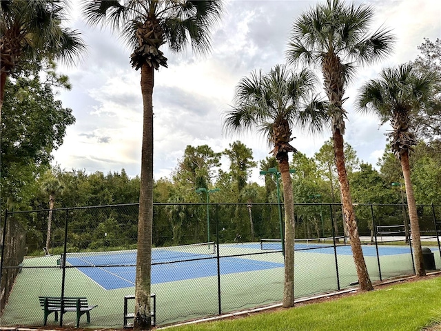 view of tennis court featuring fence