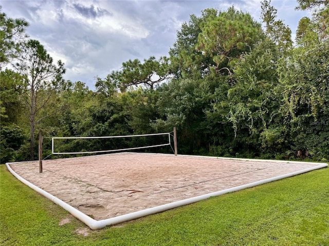 surrounding community featuring volleyball court and a lawn