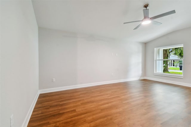 spare room with lofted ceiling, ceiling fan, and wood-type flooring