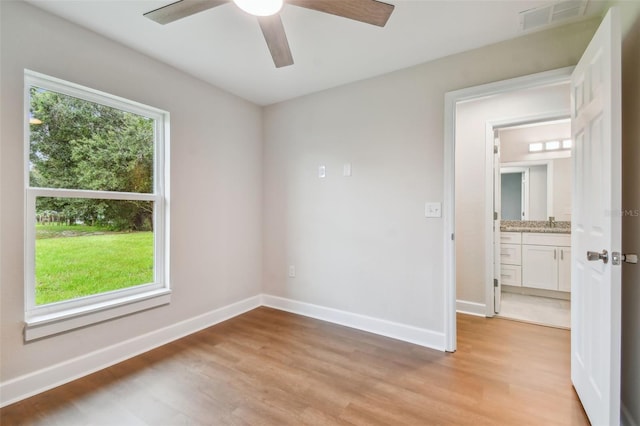 empty room with ceiling fan, wood-type flooring, and sink